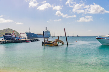 Dredging, pontoon excavator sunk in harbor in Carriacou, Grenada