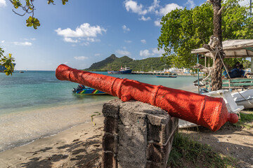 Old cannon painted orange in Tyrell bay   in Carriacou, Grenada - obrazy, fototapety, plakaty