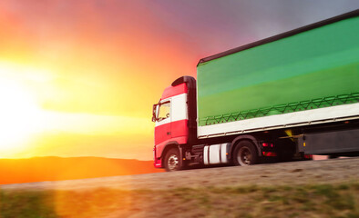 Truck with container on highway. Cargo transportation at sunset.