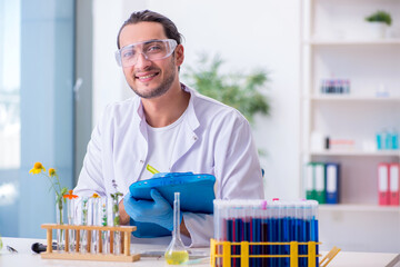 Young male chemist working in the lab