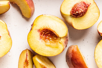 Fresh and juicy peaches halved and sliced. Close-up view.