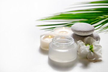 Moisturizing care skincare face cream for healing complicated troubled skin type in an open jar with visible texture. Copy space, close up, background, flat lay, top view. Coconut leaf decoration.