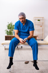 Young male doctor surgeon in fatal negligence concept