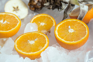 oranges lie on white ice cubes
