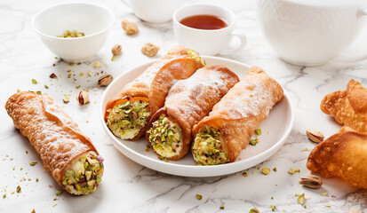 Sweet homemade cannoli stuffed with ricotta cheese  and pistachio. Sicilian dessert. Italian pastry.