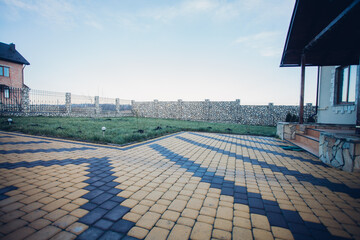 Stone pavement in perspective. Stone pavement texture. Granite cobblestoned pavement background. Abstract background of a cobblestone pavement