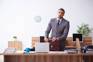 Young male employee unhappy with excessive work