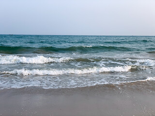 wide view of sea sore with waves and  cloudy sky in the evening 