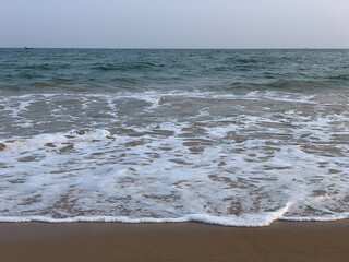 wide view of sea sore with waves and  cloudy sky in the evening 