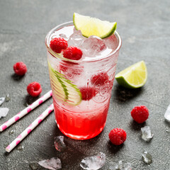 Raspberry crushed ice cold refreshing cocktail with fresh berries and lime.