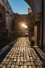 Jewish quarter or Jewish ghetto of Rome under the beautiful octavia porch, the reflection of the light at sunset illuminates the street on a summer day at sunset. Near the synagogue. Italy