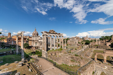 Fototapeta na wymiar Panorama of roman forum the heart of roman empire. From the Campidoglio they can be seen the Arch of Severus, the temples Saturn and Vesta, Basilica of Maxentius, Arch of Titus, Colosseum Rome, Italy.