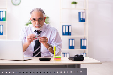 Old sick employee suffering at workplace