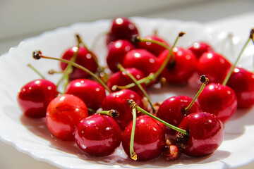Naklejka na ściany i meble A lot of cherries are in the plate.