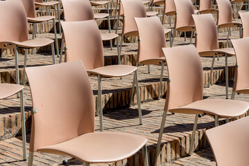 ordered chairs pattern for outdoor event with security measures