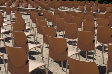 ordered chairs pattern for outdoor event with security measures