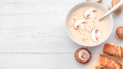 Vegetarian food and nutritious lunch concept with  top view photograph of mushroom cream soup on rustic white wooden background with copy space
