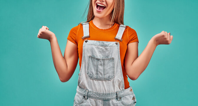 Yes i did it, celebrating great success, enjoying lucky day. Enthusiastic excited happy girl raising fist in victorious gesture.