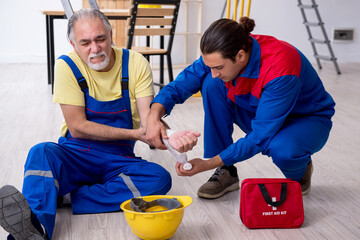 Two contractors in first aid concept