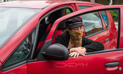 Fototapeta na wymiar Social distance in citizens life, woman in a car, on the street