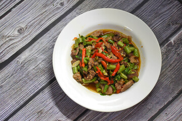 Top view of Spicy lemongrass flavored noodle soup with marinated pork chops and fried wontons (side dish)