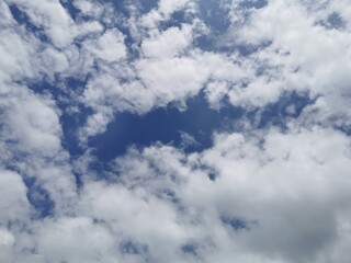 Fluffy clouds spread in the sky, 
Beautiful nature.