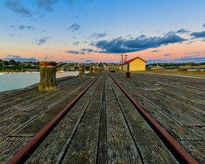 The quay in Oamaru harbour at dawn, just before sunrise.