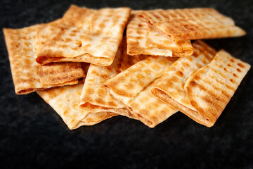 Hot crispy cookies piled on black marble. Freshly baked cookies.