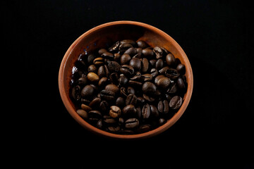 Fototapeta premium coffee in a clay cup on black velvet