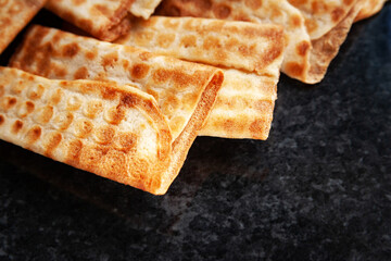 Crackling cookies piled on black marble. Freshly baked cookies.
