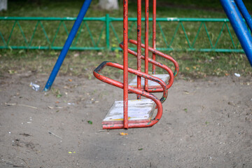 Very old swing for children. Old playground.