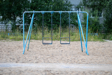 Very old swing for children. Old playground.