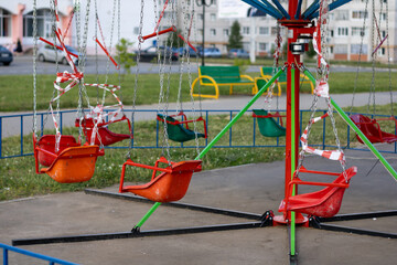 The children's carousel is wrapped in a prohibitory tape. Ban on carousel rides.