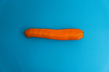 fresh carrot isolated on a blue background