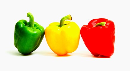 Fresh colored peppers on a white background.