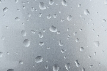 Fototapeta na wymiar rain or water drop on window glasses silver backgound