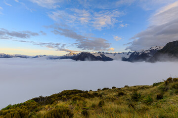 Cloud inversion over the Franz Josef valley with most of Franz Josef Glacier obscured by the clouds. After sunset, at dusk, from the view of the summit of Alex Knob. Franz Josef Glacier, New Zealand
