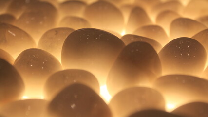 Light shining through shiny white stones giving out a golden hue