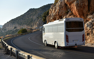 middle regular bus passing on coastal serpentine road