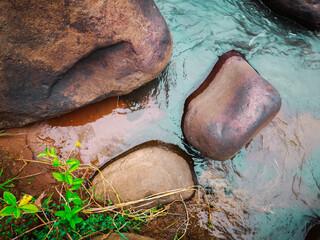 a large river stone on the river's edge