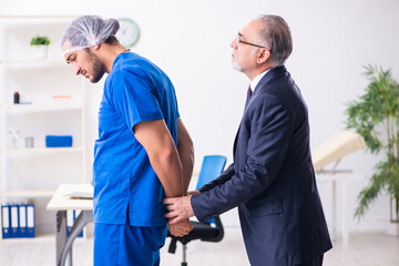 Male doctor in courthouse meeting with advocate