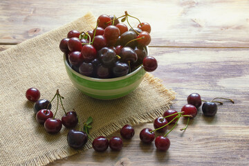 Fresh ripe cherries on rustic table. Copy space