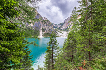 Beautiful view through the forest to Lake Braies in the Italian Alps