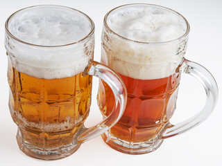 Glasses of beer on white background