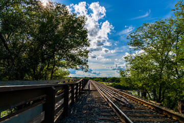 a view of the railway tracks and the pedestrian walkway on a train bridge that spans the South Saskatchewan River in Saskatoon, Saskatchewan Canada  