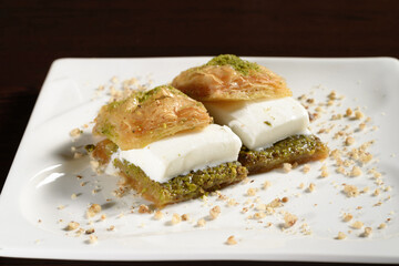 Puff baklava with ice cream on a plate, Turkish sweetness. Photos for restaurant and cafe menus