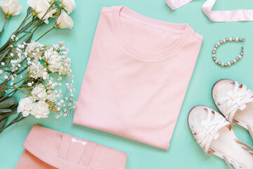 Mockup of a folded t-shirt placed surrounded by girly aaccessories and garments