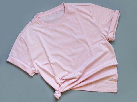 Pink t-shirt mock up flat lay on grey background