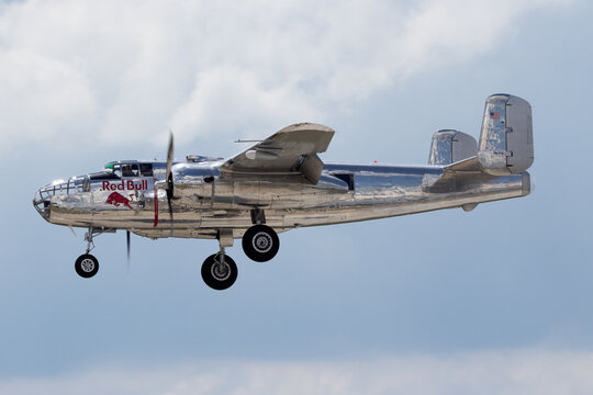 BERLIN - JUN 2, 2016: Red Bull B-25 Mitchell WWII bomber plane about to land during the Berlin Airshow ILA on Berlin-Schoneveld airport
