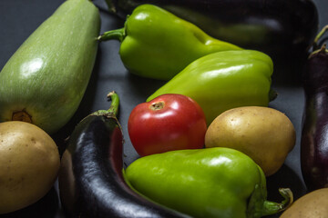 Vegetables on a black background. Various fresh vegetables lie on a black background. Harvesting.